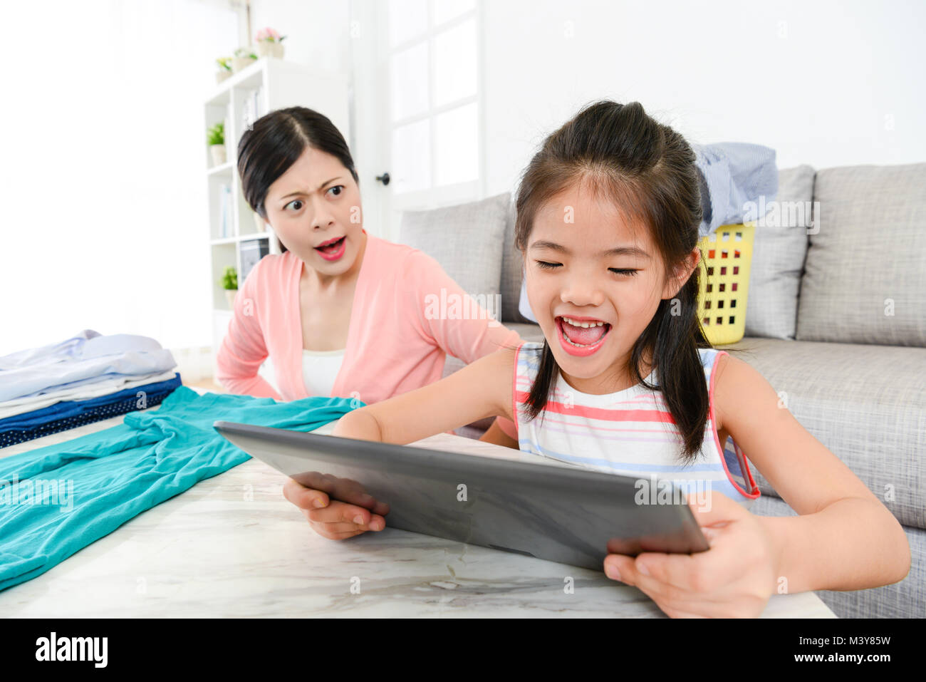 Little Girl Crying Using Tablet cheerful lovely little girl kid using mobile digital tablet playing ...