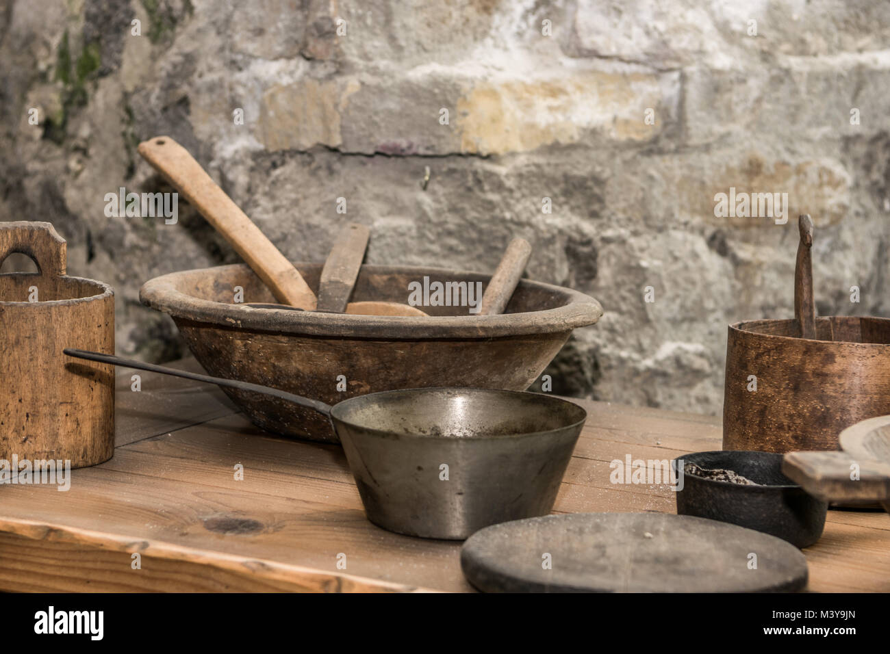 Medieval kitchen with tools, baskets, scale, fireplace Stock Photo