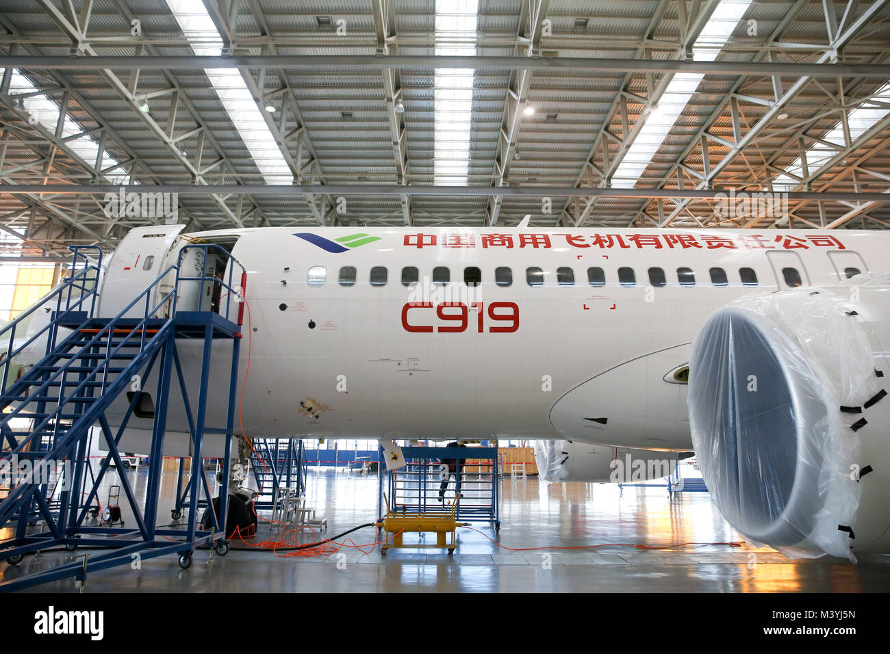 Shanghai, China. 13th Feb, 2018. China's large passenger aircraft, the C919, is seen at the assembly line in Shanghai, east China, Feb. 13, 2018. Staff members here stick to their post to test the C919 to acquire its airworthiness certificates. Credit: Ding Ting/Xinhua/Alamy Live News Stock Photo