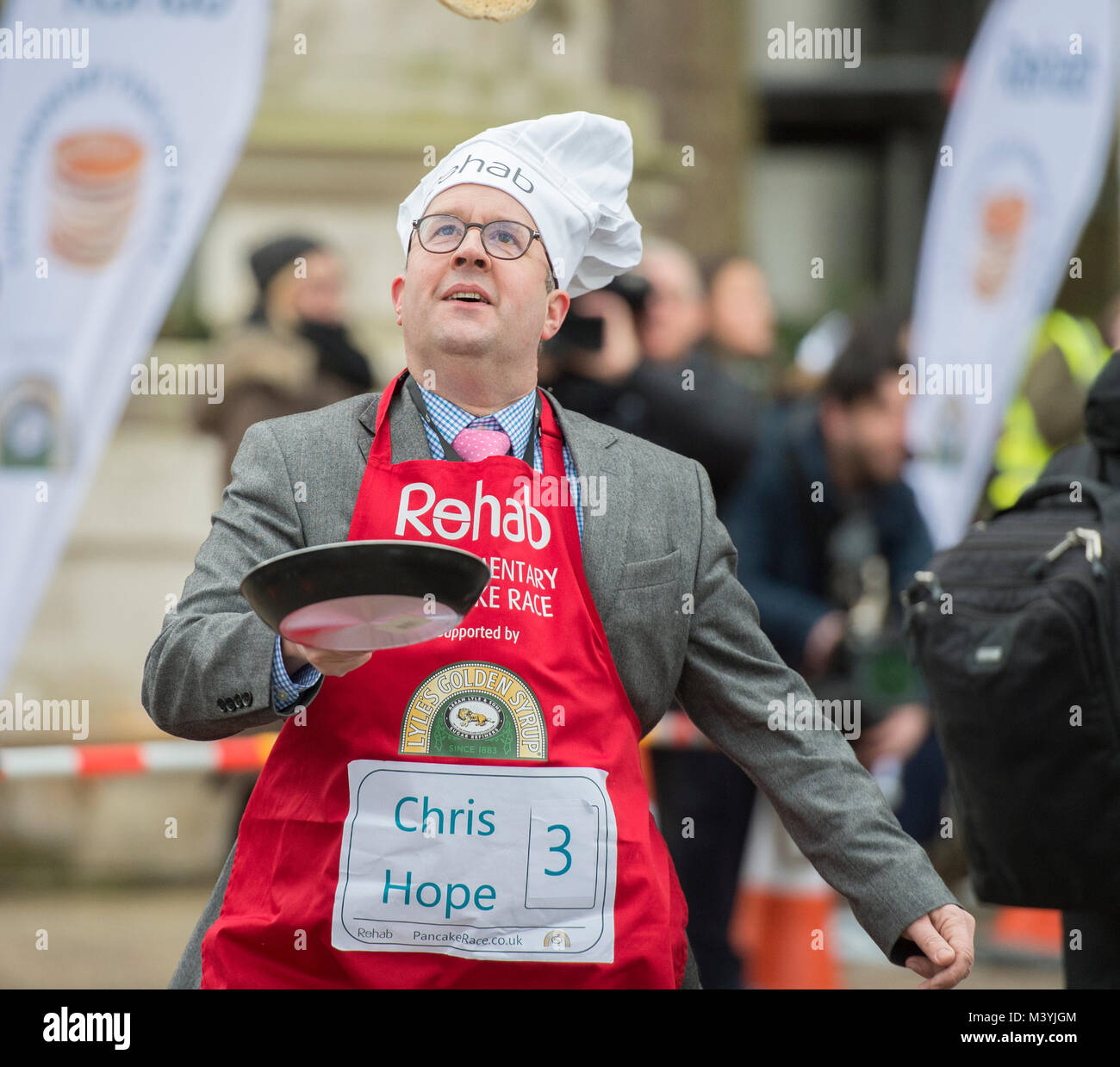 Victoria Tower Gardens, London, UK. 13 February, 2018. Media team race the Parliamentary Team at the 21st annual Rehab Parliamentary Pancake Race on Shrove Tuesday. Chris Hope of The Daily Telegraph in the race. Credit: Malcolm Park/Alamy Live News. Stock Photo