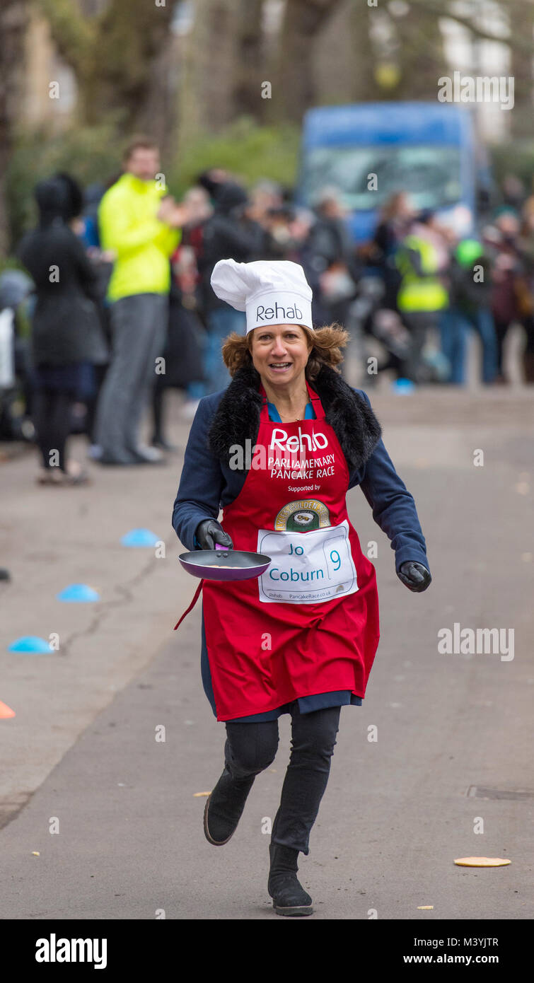 Victoria Tower Gardens, London, UK. 13 February, 2018. Media team race the Parliamentary Team at the 21st annual Rehab Parliamentary Pancake Race on Shrove Tuesday. Jo Coburn from BBC Daily Politics racing the final straight. Credit: Malcolm Park/Alamy Live News. Stock Photo