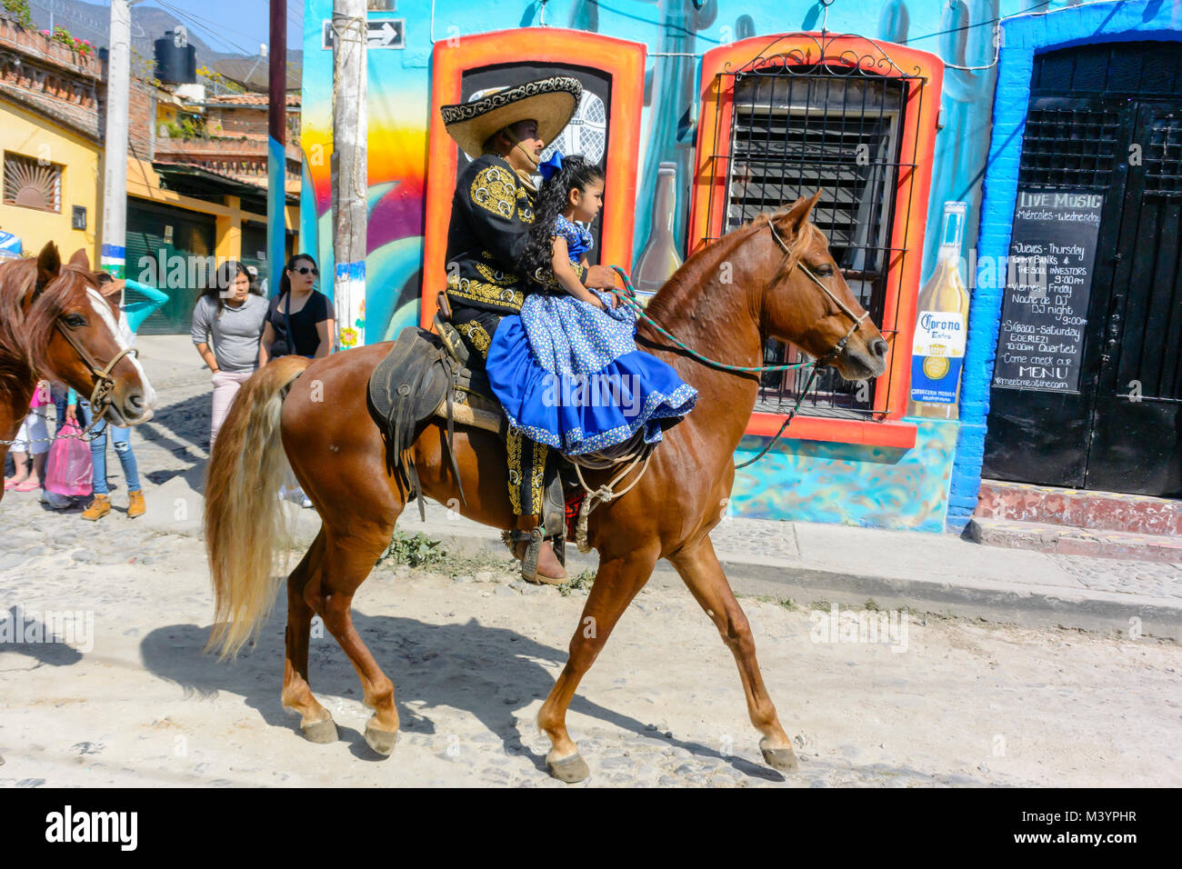 Ajijic, Jalisco State, Mexico. 13 February, 2018. Mardi Gras Festival and Parade, Mexican woman and child riding a horse. Peter Llewellyn/Alamy Live News Stock Photo