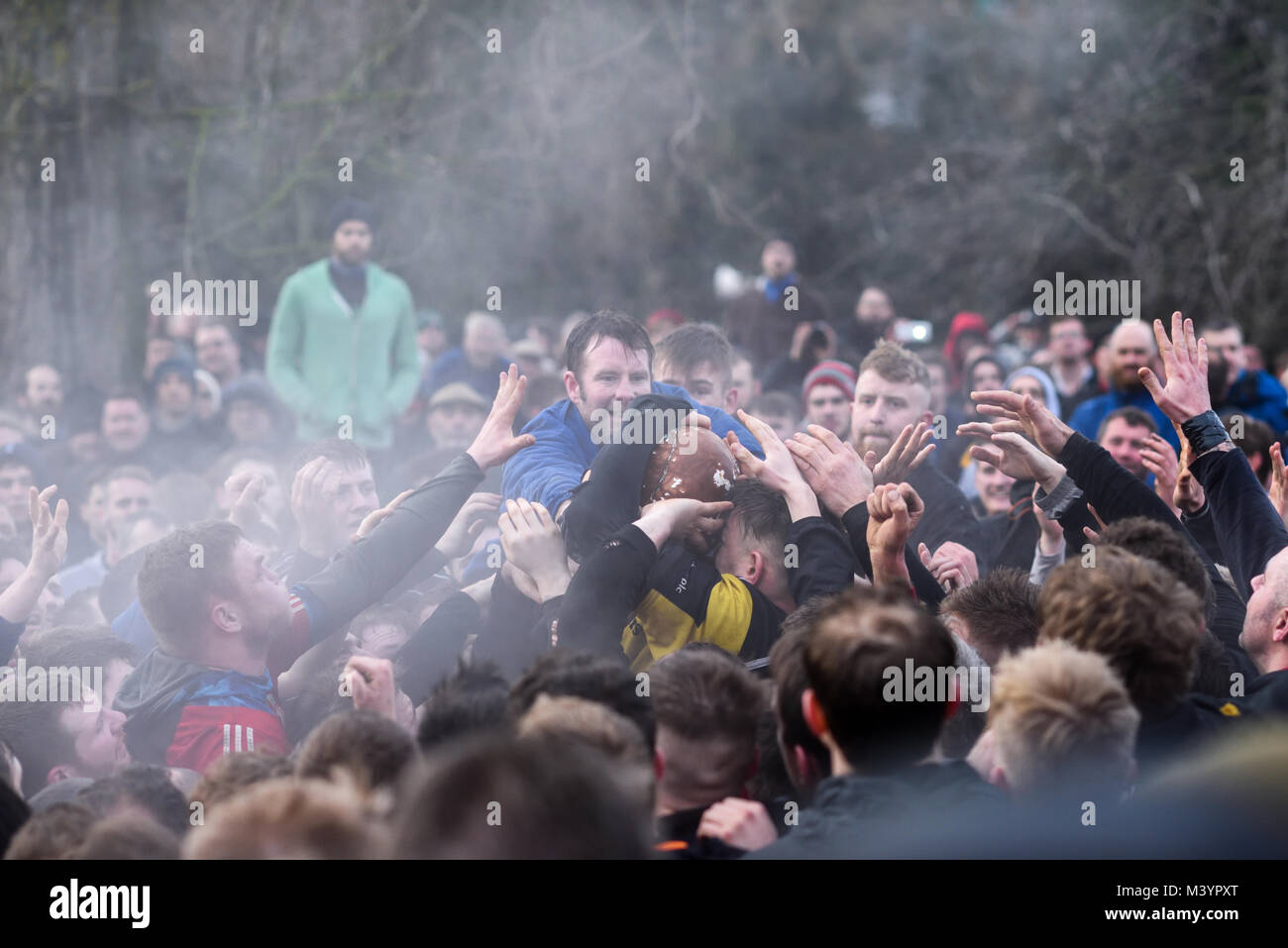 Ashbourne, Derbyshire, UK:13th February 2018: Shrove Tuesday and the first day of royal Shrovetide football in the market town of Ashbourne.Thousand turning out in the driving rain to watch the up'ards and down'ards do battle for the ball.The game started at 14.00hrs and can go on until 22.00hrs tonight unless a ball is goaled after 1700hrs.Then they do it all again tomorrow. Credit: Ian Francis/Alamy Live News Stock Photo