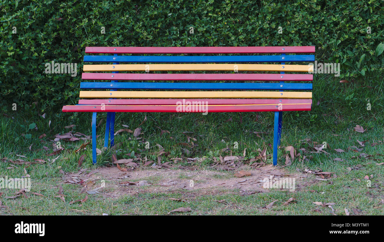 A colorful park bench at a playground. Stock Photo