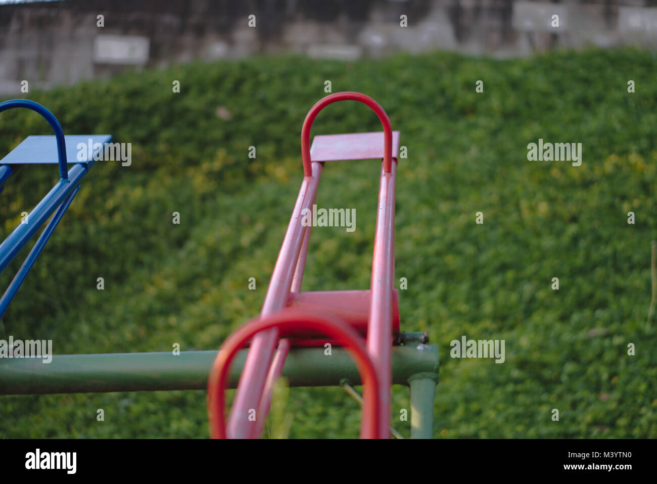 Red and colorful seesaws at a playground. Stock Photo
