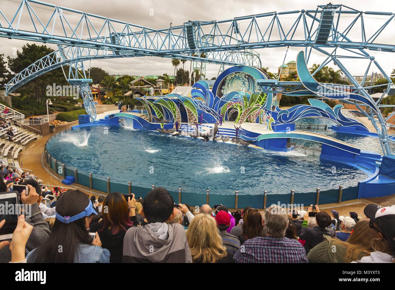 Visitors watching Dolphin Days Outdoors Tourist Travel Attractions Show in San Diego California SeaWorld Theme Park Stock Photo