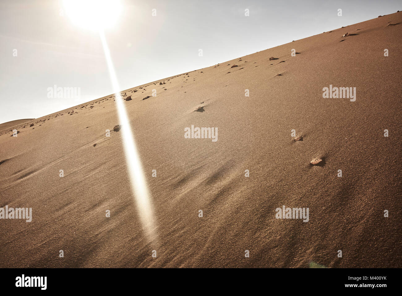 Sands of the Atacama Desert in Chile. A thick sun beam beaming down. Dutch angle. Stock Photo