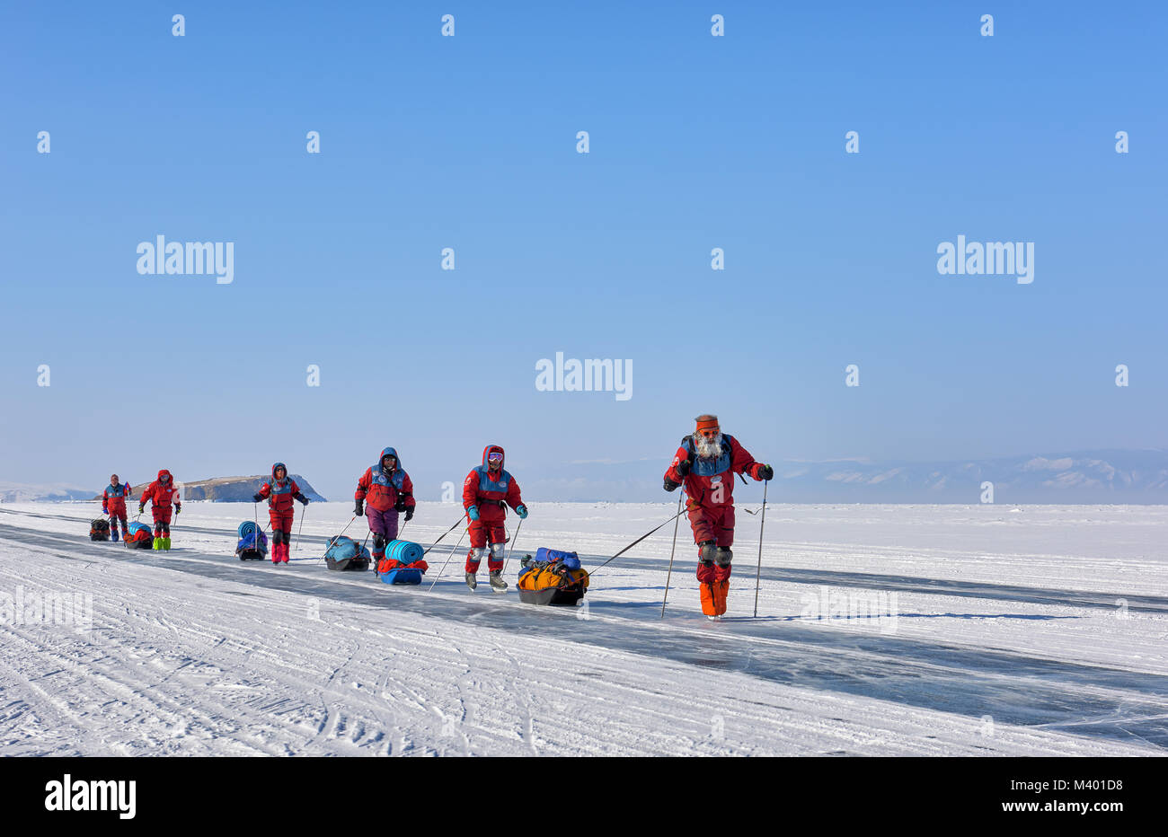 LAKE BAIKAL, IRKUTSK REGION, RUSSIA - March 08, 2017: Expedition on ice of Baikal to test Arctic equipment in low temperature conditions. A group of r Stock Photo