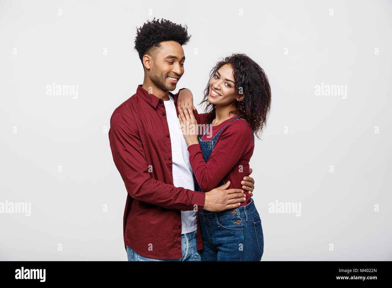 portrait of happy african american couple hug each other on white ...