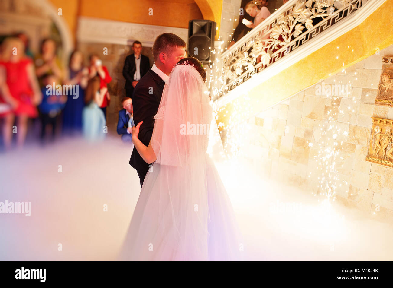 Happy young wedding couple dancing their first dance with different ...