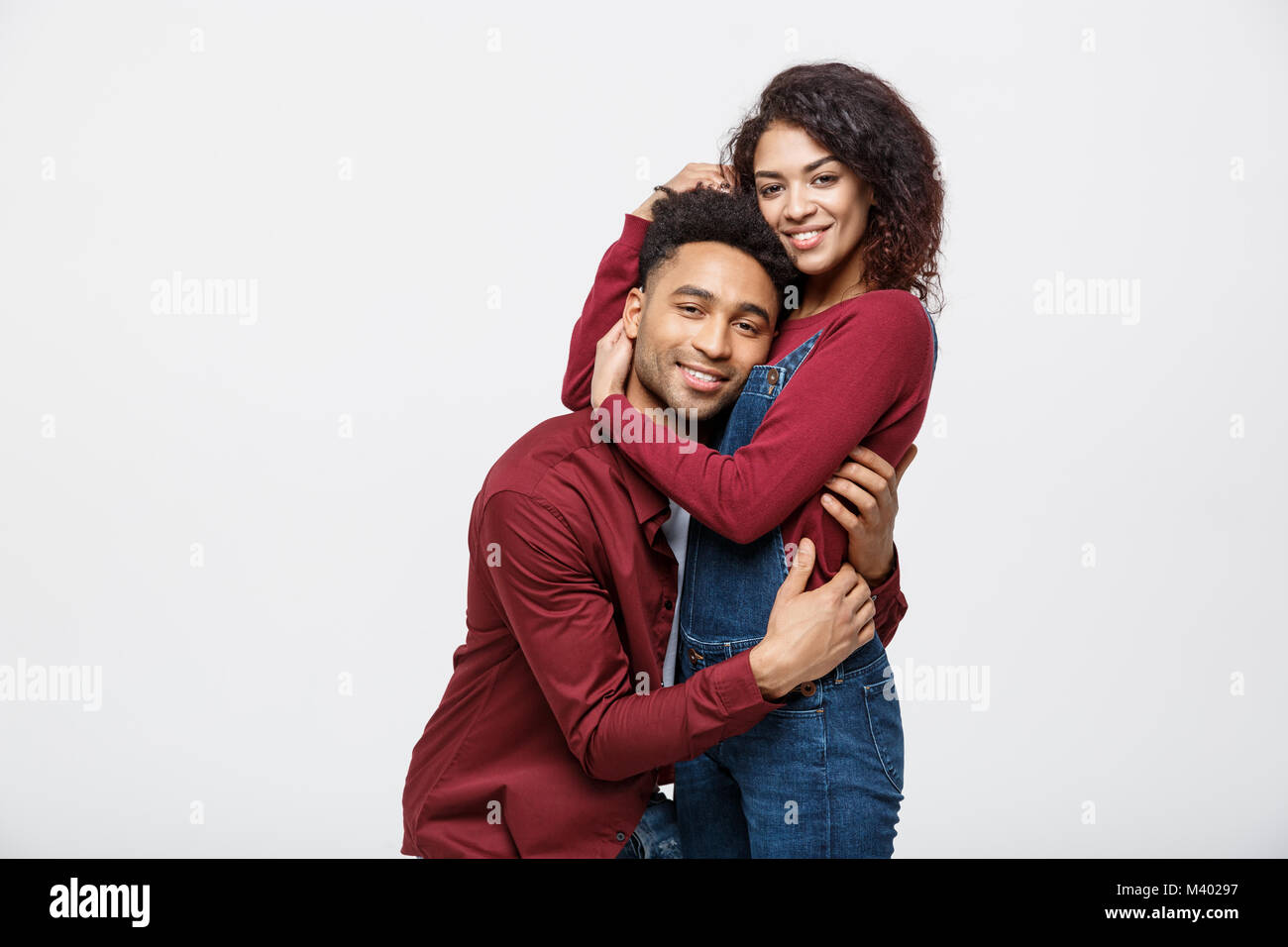 portrait of happy african american couple hug each other on white ...