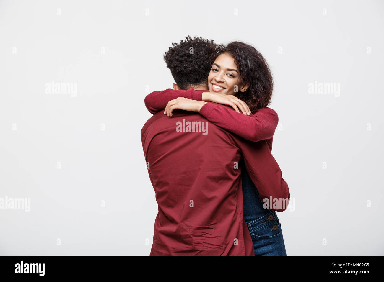 portrait of happy african american couple hug each other on white ...