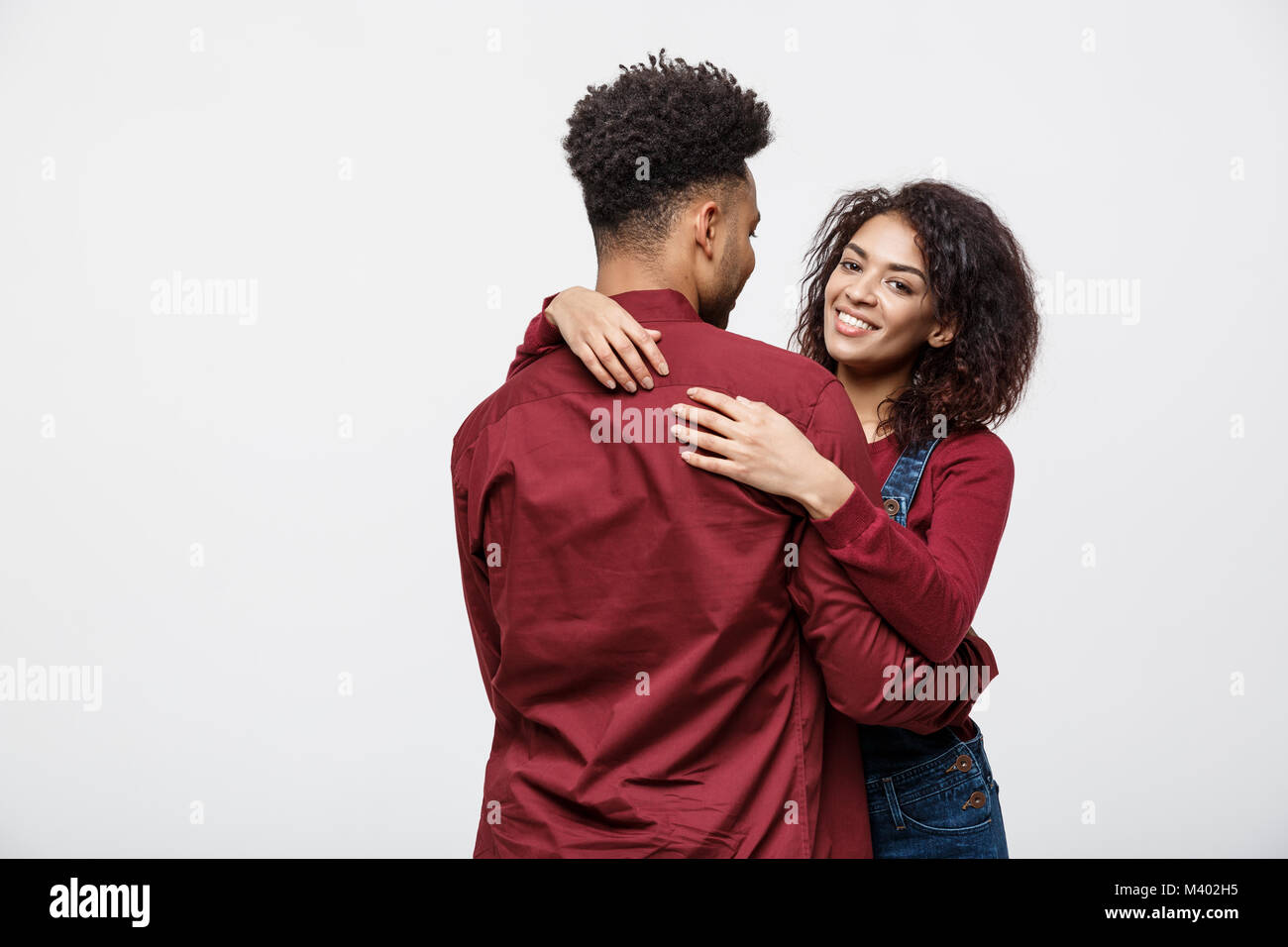 portrait of happy african american couple hug each other on white ...