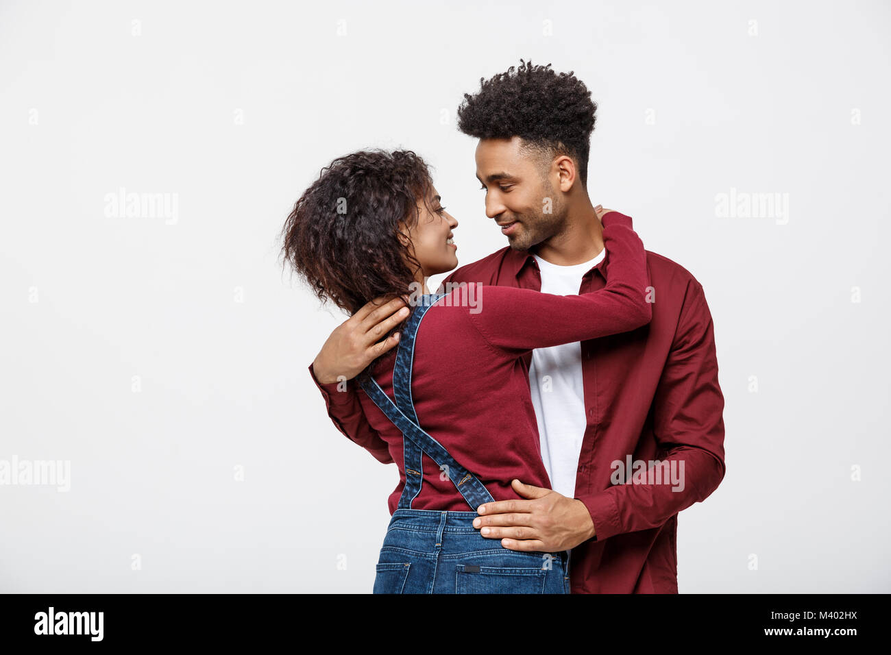 portrait of happy african american couple hug each other on white ...
