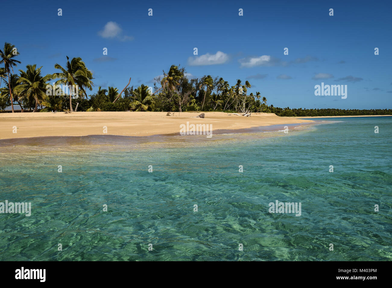 Clear blue sea and white sand beach with coconut palms, Uoleva, Tonga Stock Photo