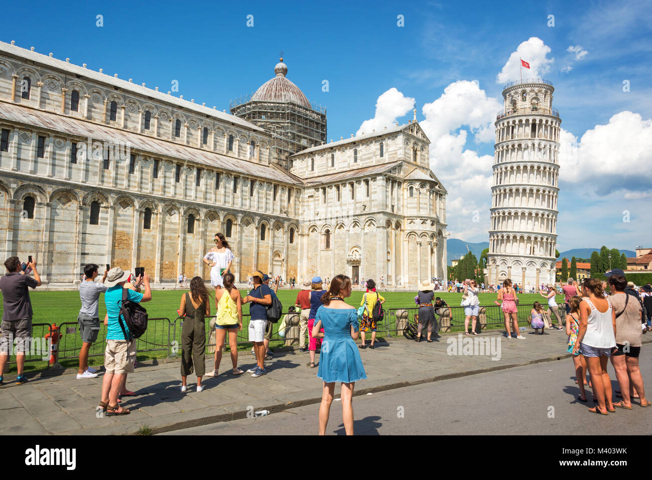 People having fun and taking pictures of the leaning tower of Pisa in Tuscany, Italy Stock Photo