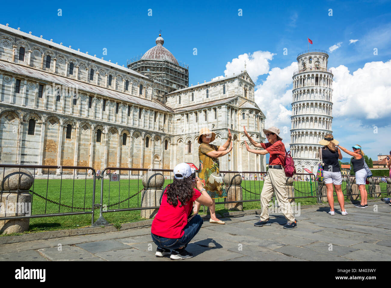 People having fun and taking pictures of the leaning tower of Pisa in Tuscany, Italy Stock Photo