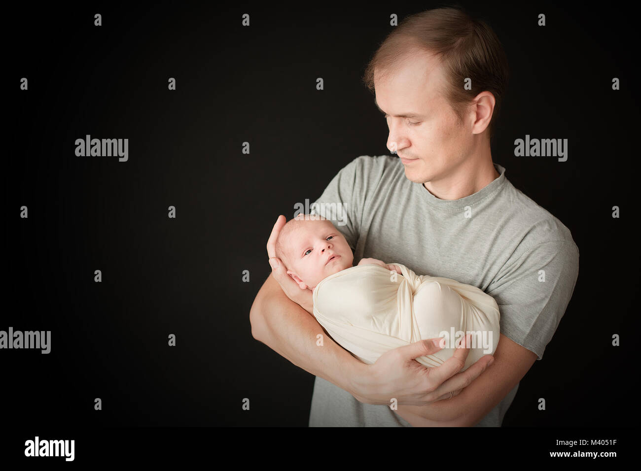 male hand father holding gray made from 97 percent organic cotton infant  baby socks Stock Photo - Alamy