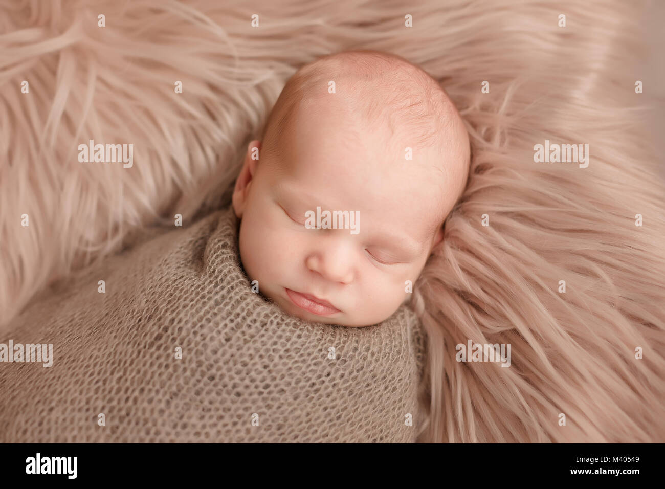 Sleeping newborn baby boy swaddled in a blanket Stock Photo Alamy