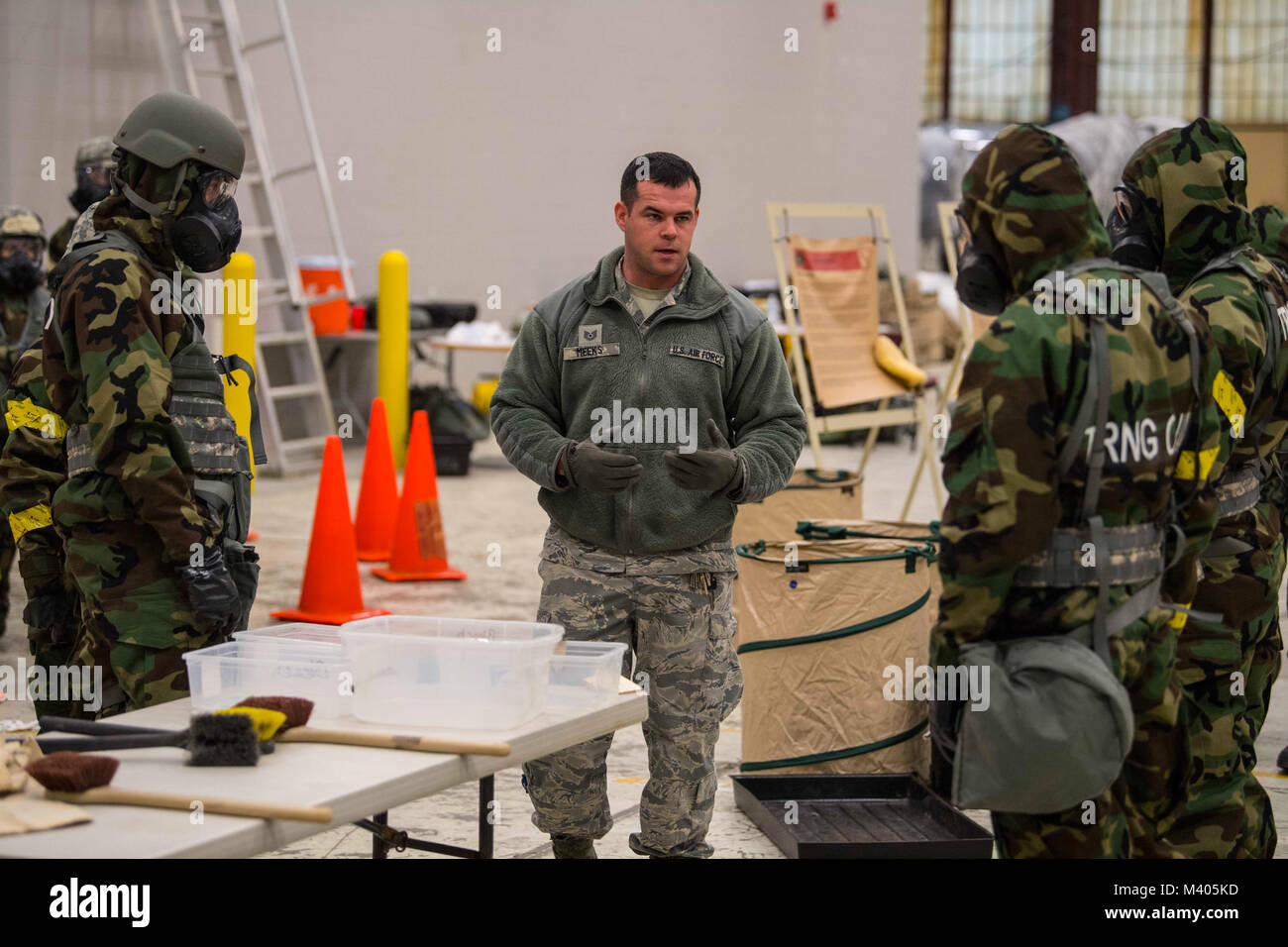 Tech. Sgt. Phillip Meeks explains the process of decontamination in the event of a chemical, biological, radiological, nuclear and explosives (CBRNE) attack during training Feb. 4, 2018 at McLaughlin Air National Guard Base, Charleston, West Virginia. 130th Airman trained over drill weekend in various disciplines to improve their overall readiness in the event of an attack at home or abroad. (U.S. Air National Guard photo by Tech. Sgt. De-Juan Haley) Stock Photo