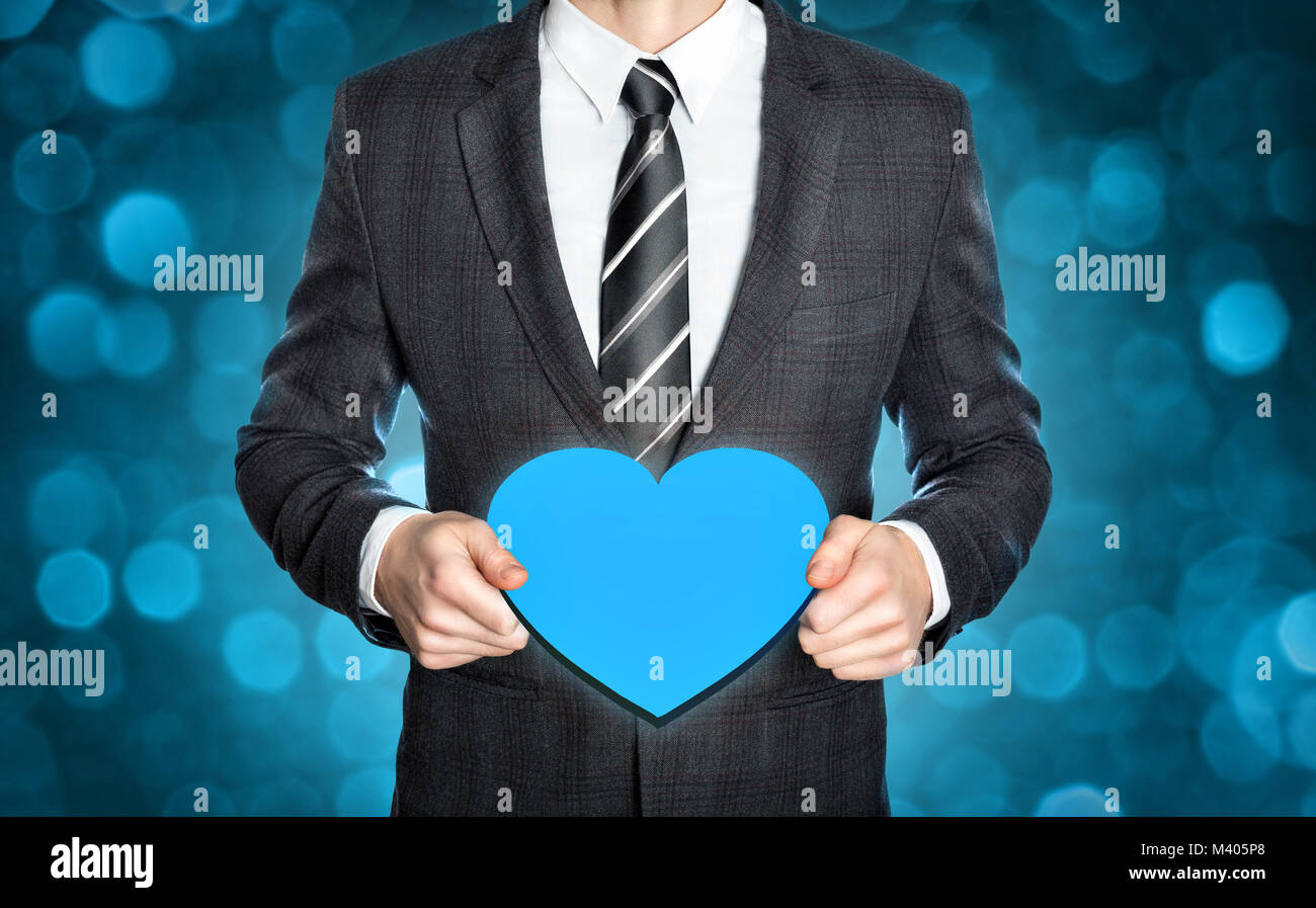 Businessman holding a heart symbol Stock Photo