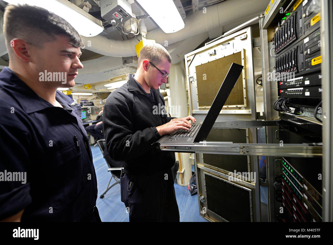 180205-N-ZU710-010  Atlantic Ocean (February 5, 2018) Sonar Technician 3rd Class Matt Mickinak and Sonar Technician Seaman David Cooper perform maintenance on sonar control equipment aboard the Arleigh Burke-class guided-missile destroyer USS Winston S. Churchill (DDG 81). Churchill is underway as part of the Harry S. Truman Carrier Strike Group (HSTCSG) conducting a Composite Training Unit Exercise (COMPTUEX), which evaluates the strike group's ability as a whole to carry out sustained combat operations from the sea, ultimately certifying the HSTCSG for deployment. (U.S. Navy Photo by Mass Co Stock Photo