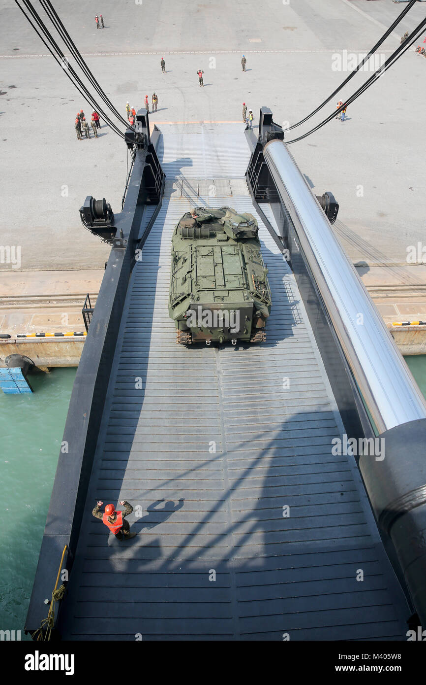 180206-N-IX266-005 LAEM CHABANG, Thailand—An amphibious assault vehicle rolls off the ramp of Military Sealift Command’s (MSC) large, medium-speed, roll-on/roll-off ship USNS Pililaau (T-AK 304) during an offload at the port here to deliver equipment in support of Cobra Gold 2018, Feb. 5. The USNS Pililaau is part of Maritime Prepositioning Ships Squadron THREE, which consists of a fleet of government-owned ships operated by MSC and is based in the Guam-Saipan area of the Western Pacific Ocean. CG18 is a Thailand and United States co-sponsored exercise conducted annually in the Kingdom of Thai Stock Photo