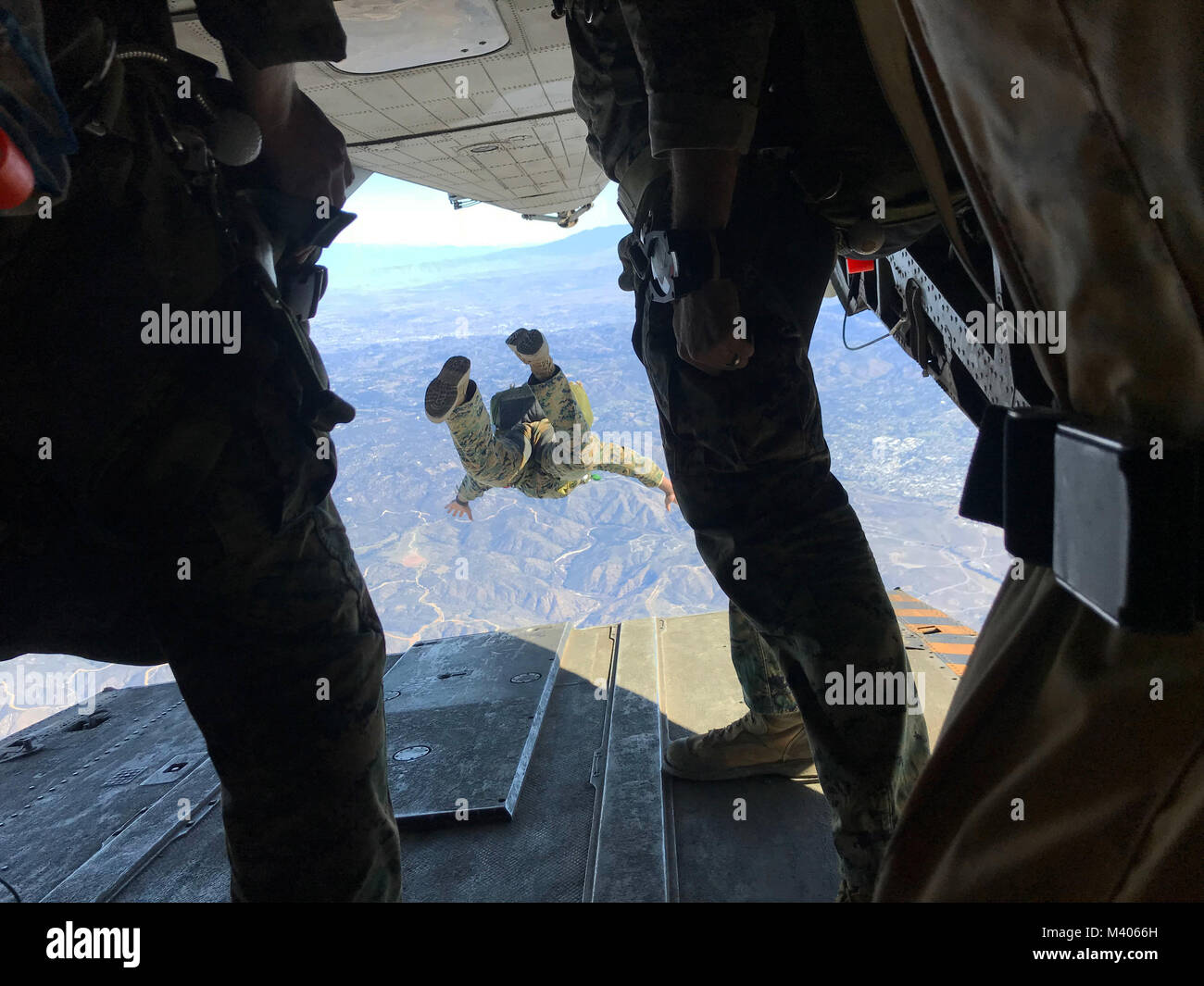 Marines with 1st Marine Reconnaissance Battalion execute a 10,000-foot jump from a CH-53E with Marine Heavy Helicopter Squadron (HMH) 465 over Marine Corps Base Camp Pendleton, Calif., Feb. 6. During parachute and flight operations, the ground combat element and the air combat element work together to ensure safety and mission accomplishment during training. (U.S. Marine Corps photo by Sgt. David Bickel/Released) Stock Photo