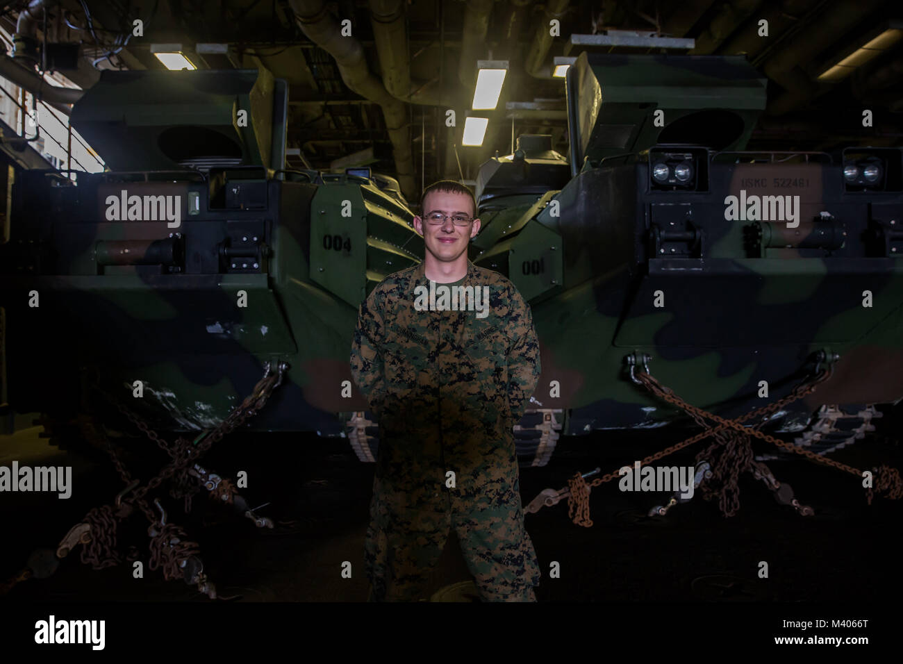 U.S. Marine Lance Cpl. Jerimiah Cunningham stands in front of amphibious assault vehicles aboard the amphibious assault ship U.S.S. Bonhomme Richard (LHD-6), at sea, Feb. 6, 2018. Cunningham, a Parkersburg, West Virginia native, serves as a team leader with Lima Company, 3rd Battalion, 3rd Marine Regiment, 3rd Marine Division. The Hawaii-based battalion will participate in Exercise Cobra Gold 18, an annual exercise conducted in the Kingdom of Thailand held from Feb. 13-23 with seven nations participating. (U.S. Marine Corps photo by Sgt. Ricky Gomez) Stock Photo