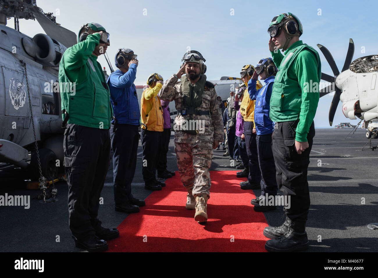 180206-N-GP724-1042 ARABIAN GULF (Feb. 6, 2018) Sideboys render honors to Qatar Emiri Naval Forces Maj. Gen. Abdullah Hassan Al-Sulaiti on the flight deck of the aircraft carrier USS Theodore Roosevelt (CVN 71). Theodore Roosevelt and its carrier strike group are deployed to the U.S. 5th Fleet area of operations in support of maritime security operations to reassure allies and partners and preserve the freedom of navigation and the free flow of commerce in the region. (U.S. Navy photo by Mass Communication Specialist 3rd Class Alex Perlman/Released) Stock Photo