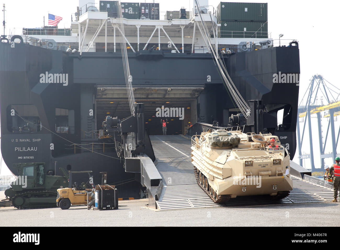 180206-N-IX266-009 LAEM CHABANG, Thailand— An amphibious assault vehicle rolls off the ramp of Military Sealift Command’s (MSC) large, medium-speed, roll-on/roll-off ship USNS Pililaau (T-AK 304) during an offload at the port here to deliver equipment in support of Cobra Gold 2018, Feb. 5. The USNS Pililaau is part of Maritime Prepositioning Ships Squadron THREE, which consists of a fleet of government-owned ships operated by MSC and is based in the Guam-Saipan area of the Western Pacific Ocean. CG18 is a Thailand and United States co-sponsored exercise conducted annually in the Kingdom of Tha Stock Photo