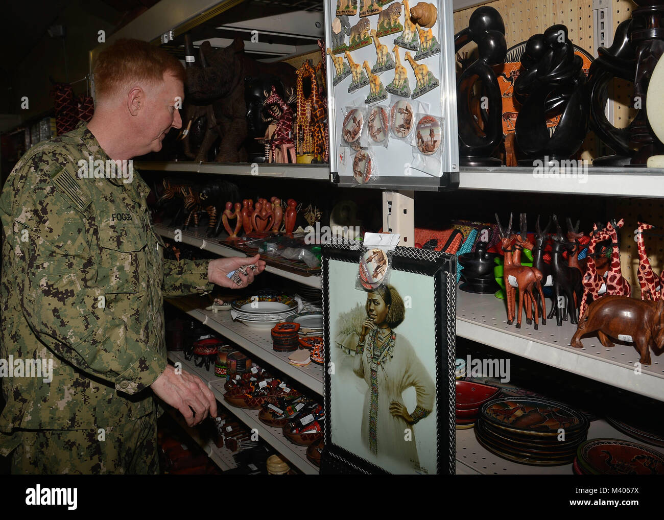 180206-N-JY474-040 CAMP LEMONNIER, Djibouti – While being given a tour of the Camp Lemonnier Navy Exchange Adm. James G. Foggo, Commander U.S. Naval Forces Europe - Africa, browses the store’s merchandise, Feb. 6. The purpose of Foggo’s visit was to visit the Sailors currently forward deployed to Camp Lemonnier. (U.S. Navy photo by Mass Communication Specialist 2nd Class Jared E. Walker/Released). Stock Photo