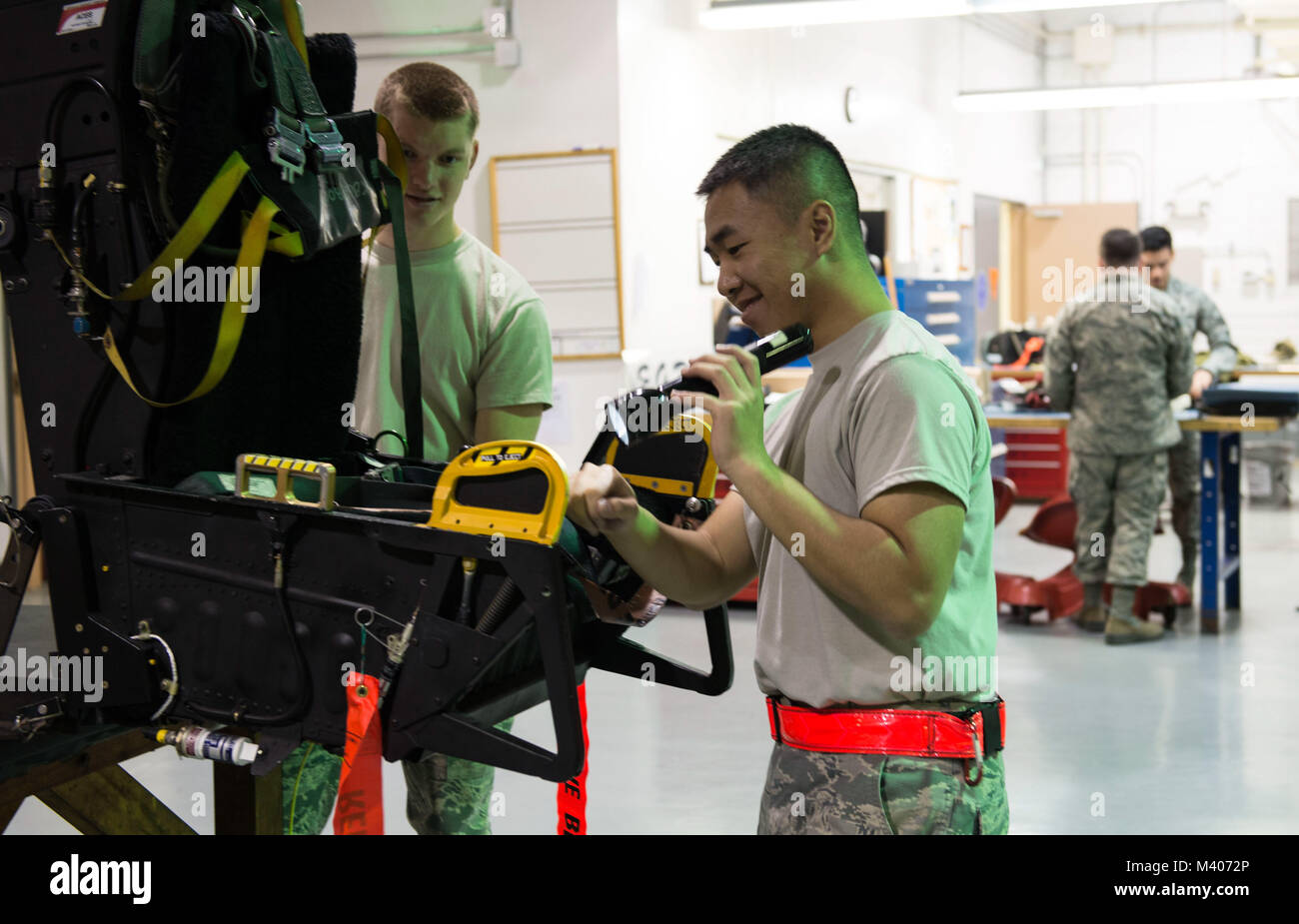 Airmen from the 18th Component Maintenance Squadron egress shop perform a visual inspection of an ejection seat Feb. 7, 2018, at Kadena Air Base, Japan. Egress is a specialized career field and requires attention to detail at all times. (U.S. Air Force photo by Senior Airman Jessica H. Smith) Stock Photo
