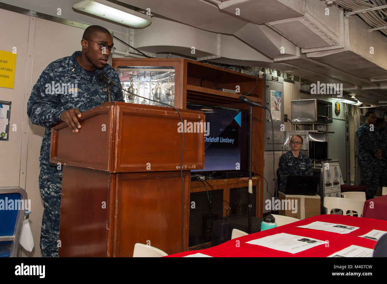 180207-N-NB544-025  SOUTH CHINA SEA (Feb. 7, 2018) Ensign Christoff Lindsey speaks to Sailors during an African American/Black History Month celebration on the mess decks of the amphibious assault ship USS Bonhomme Richard (LHD 6). Bonhomme Richard is operating in the Indo-Asia-Pacific region as part of a regularly scheduled patrol and provides a rapid-response capability in the event of a regional contingency or natural disaster. (U.S. Navy photo by Mass Communication Specialist 2nd Class Kyle Carlstrom/Released) Stock Photo