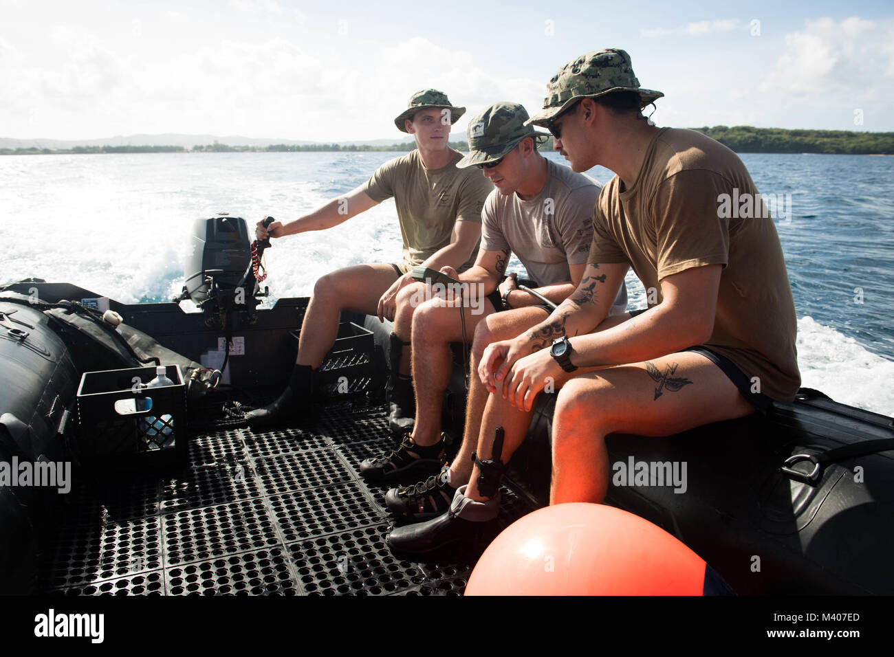 Sailors assigned to Explosive Ordnance Disposal Mobile Unit 5 (EODMU-5) prepare to conduct underwater mine countermeasures training in Apra Harbor, Guam, Feb. 7, 2018. EODMU5 conducts counter IED operations, renders safe explosive hazards and disarms underwater explosives. EODMU-5 is assigned to Commander, Task Force 75, the primary expeditionary task force responsible for the planning and execution of coastal riverine operations, explosive ordnance disposal, diving engineering and construction, and underwater construction in the U.S. 7th Fleet area of operations.  (U.S. Navy Combat Camera pho Stock Photo