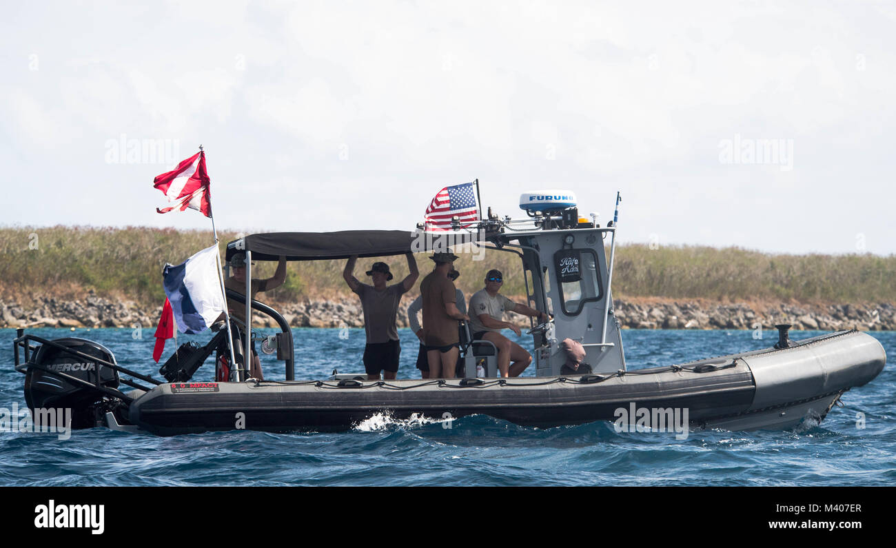 Sailors assigned to Explosive Ordnance Disposal Mobile Unit 5 (EODMU-5) conduct underwater mine countermeasures training in Apra Harbor, Guam, Feb. 7, 2018. EODMU5 conducts counter IED operations, renders safe explosive hazards and disarms underwater explosives. EODMU-5 is assigned to Commander, Task Force 75, the primary expeditionary task force responsible for the planning and execution of coastal riverine operations, explosive ordnance disposal, diving engineering and construction, and underwater construction in the U.S. 7th Fleet area of operations.  (U.S. Navy Combat Camera photo by Mass  Stock Photo