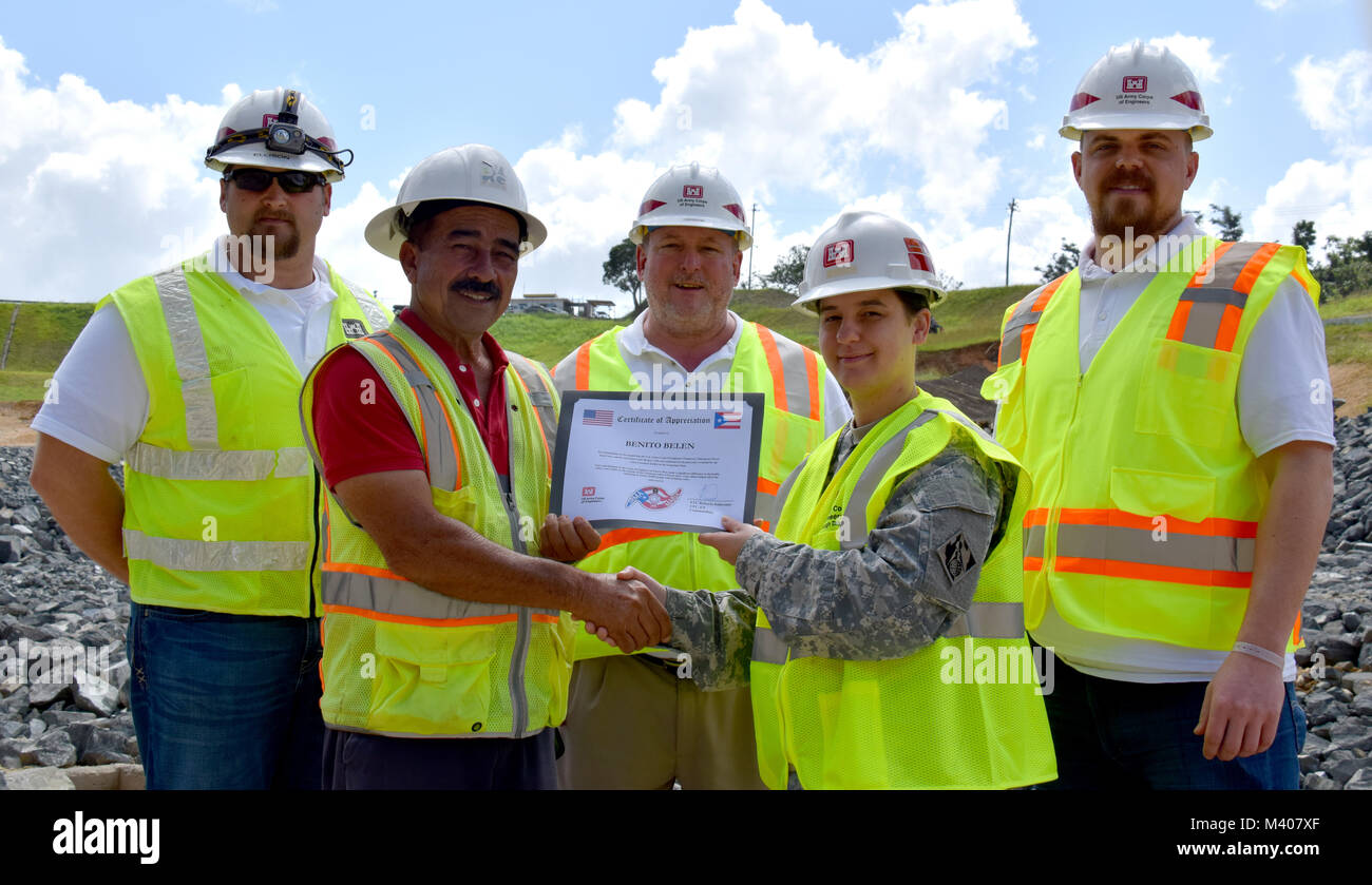 A certificate of appreciation was presented to Mr. Benito Belen, a local construction worker, by MAJ Kimberly Giles, Recovery Field Office Deputy Commander, for constructing a temporary bridge that allowed the Temporary Power Team to remove and install a new generator at the Guajataca Dam, restoring water to roughly 44,000 people, February 8, 2018.  Jacob Ellison, Benito Belen, Timothy Rainy, MAJ Kimberly Giles, Bill Spring (left to right). Stock Photo