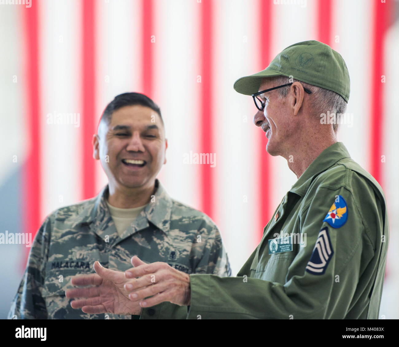 Jeff Intemann, a Vietnam Veteran from Vacaville, Calif., speaks with U.S. Air Force Chief Master Sgt. Marcos Malacara of the 60th Diagnostics and Therapeutics Squadron during the 75th Anniversary kickoff celebration at Travis Air Force Base, Calif., Feb. 8, 2018. The celebration featured the inaugural unveiling of the 75th Anniversary logo on a C-17 Globemaster III. Travis is celebrating 75 years as a major strategic logistics hub for the Pacific and integral part of global power projection for the total force. (U.S. Air Force photo by Louis Briscese) Stock Photo
