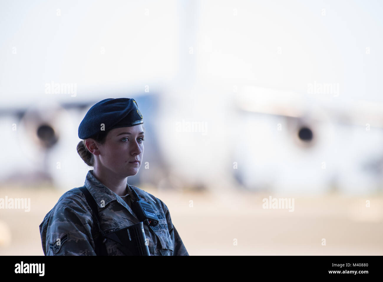 A Security Forces Airmen stands guard on the flight line during the 75th Anniversary kickoff celebration at Travis Air Force Base, Calif., Feb. 8, 2018. The celebration featured the inaugural unveiling of the 75th Anniversary logo on a C-17 Globemaster III. Travis is celebrating 75 years as a major strategic logistics hub for the Pacific and integral part of global power projection for the total force. (U.S. Air Force photo by Master Sgt. Joey Swafford) Stock Photo