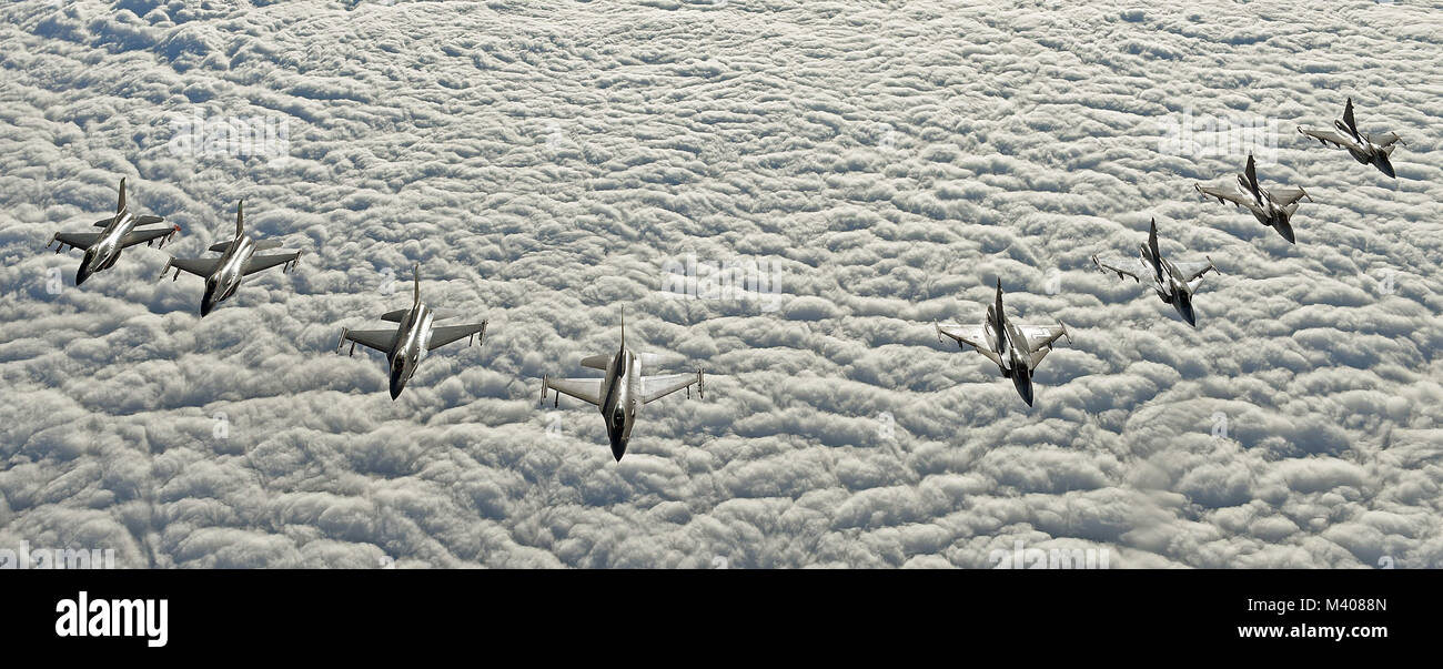 Four U.S. Air Force F-16C Fighting Falcons and four Swedish Air Force JAS 39 Gripens fly in formation during aerial refueling training in Swedish airspace, Feb. 8, 2018. The air refueling training is in conjunction with a rotational deployment of F-16Cs from the Ohio Air National Guard’s 180th Fighter Wing to Amari Air Base, Estonia, as part of a Theater Security Package. The training allows the U.S. and Sweden to strengthen interoperability and increase readiness.  (U.S. Air Force photo by Airman 1st Class Luke Milano) Stock Photo