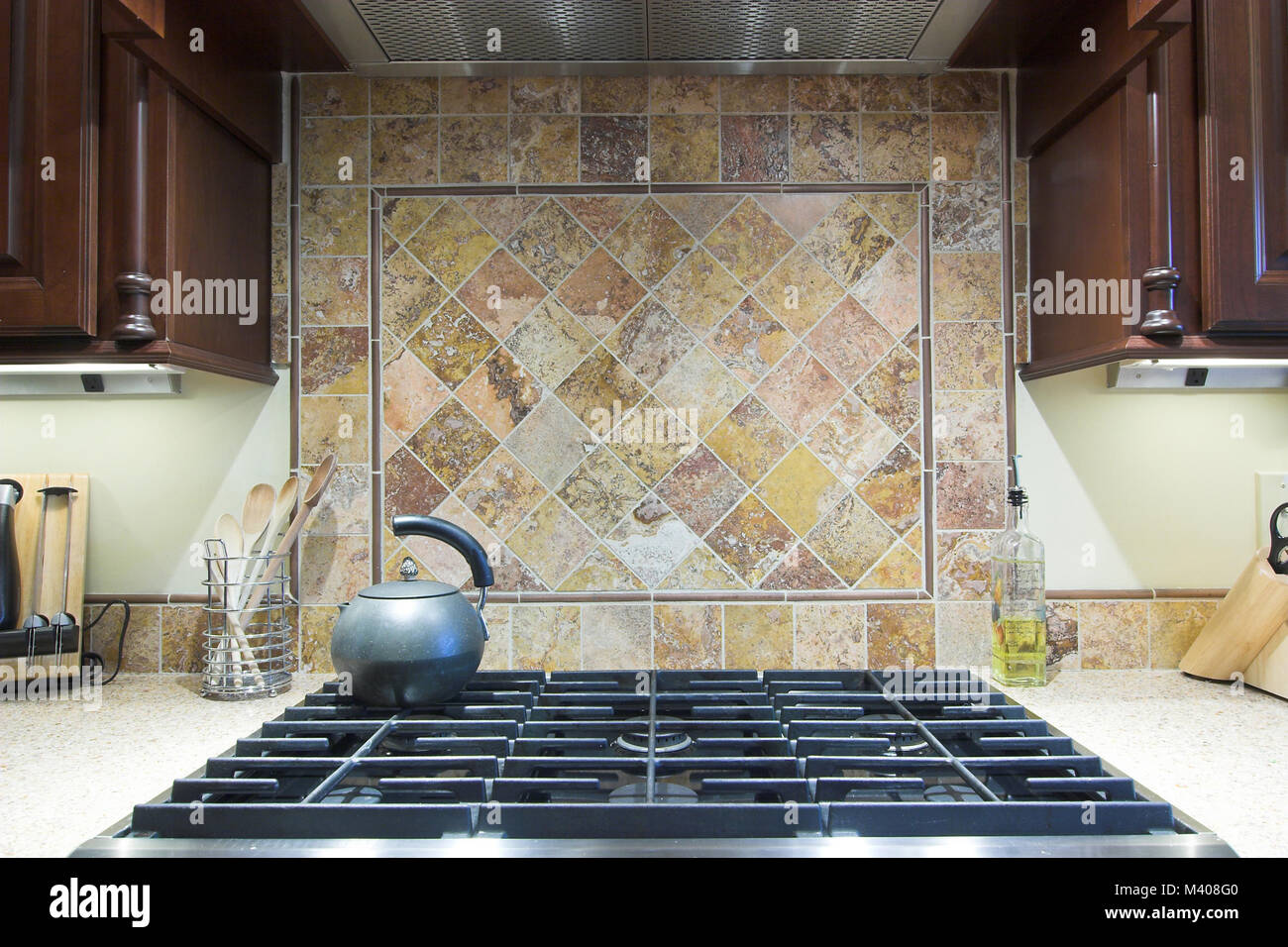 expensive industrial cooktop with tile backsplash Stock Photo Alamy