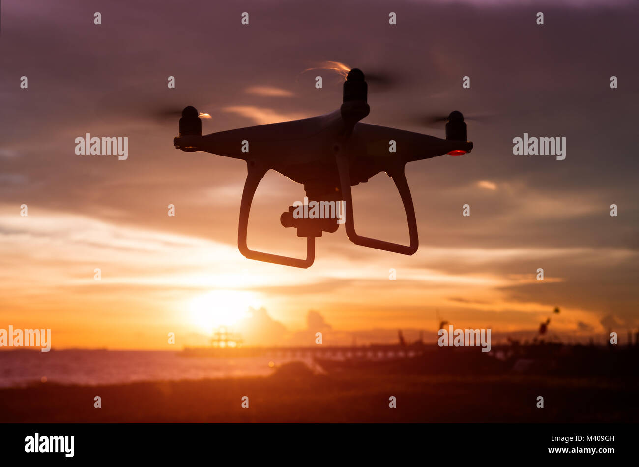 Silhouette of flying drone in sunset low lighting time Stock Photo Alamy