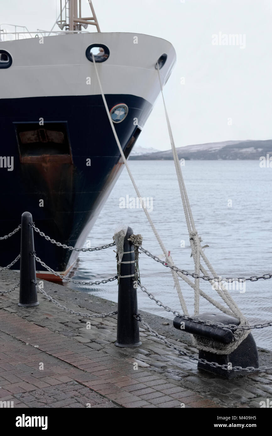 Anchorline rope ship tied at port dock at sea coast Stock Photo