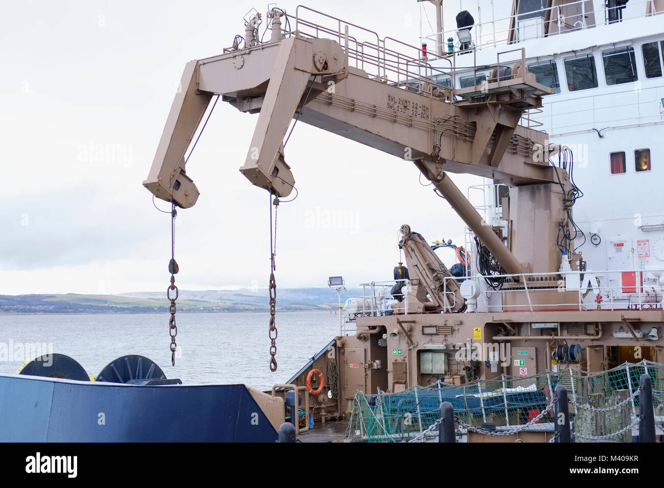 Ship crane transport cargo at port dock Stock Photo