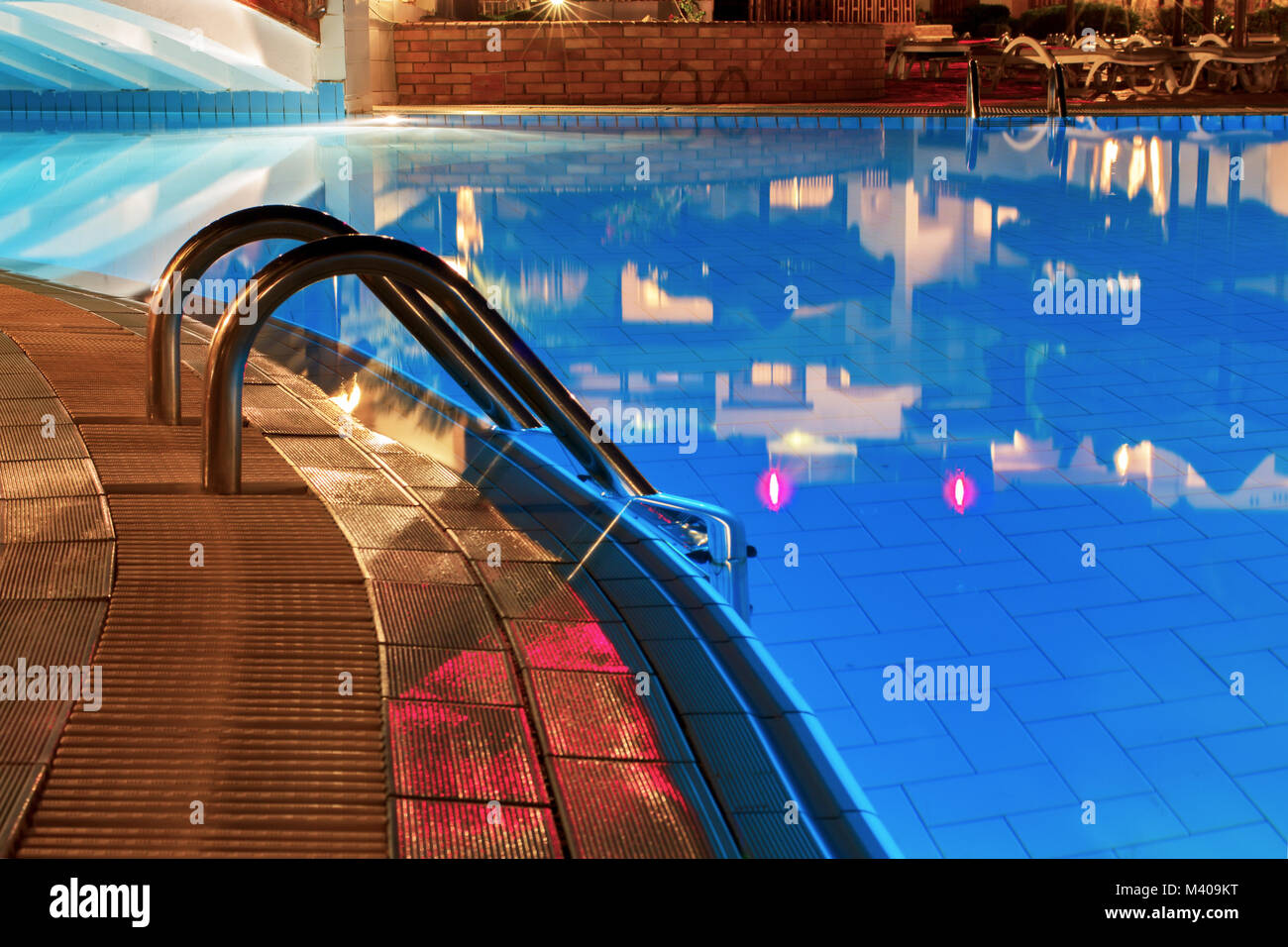 Blue water and handrails to enter the water Stock Photo - Alamy