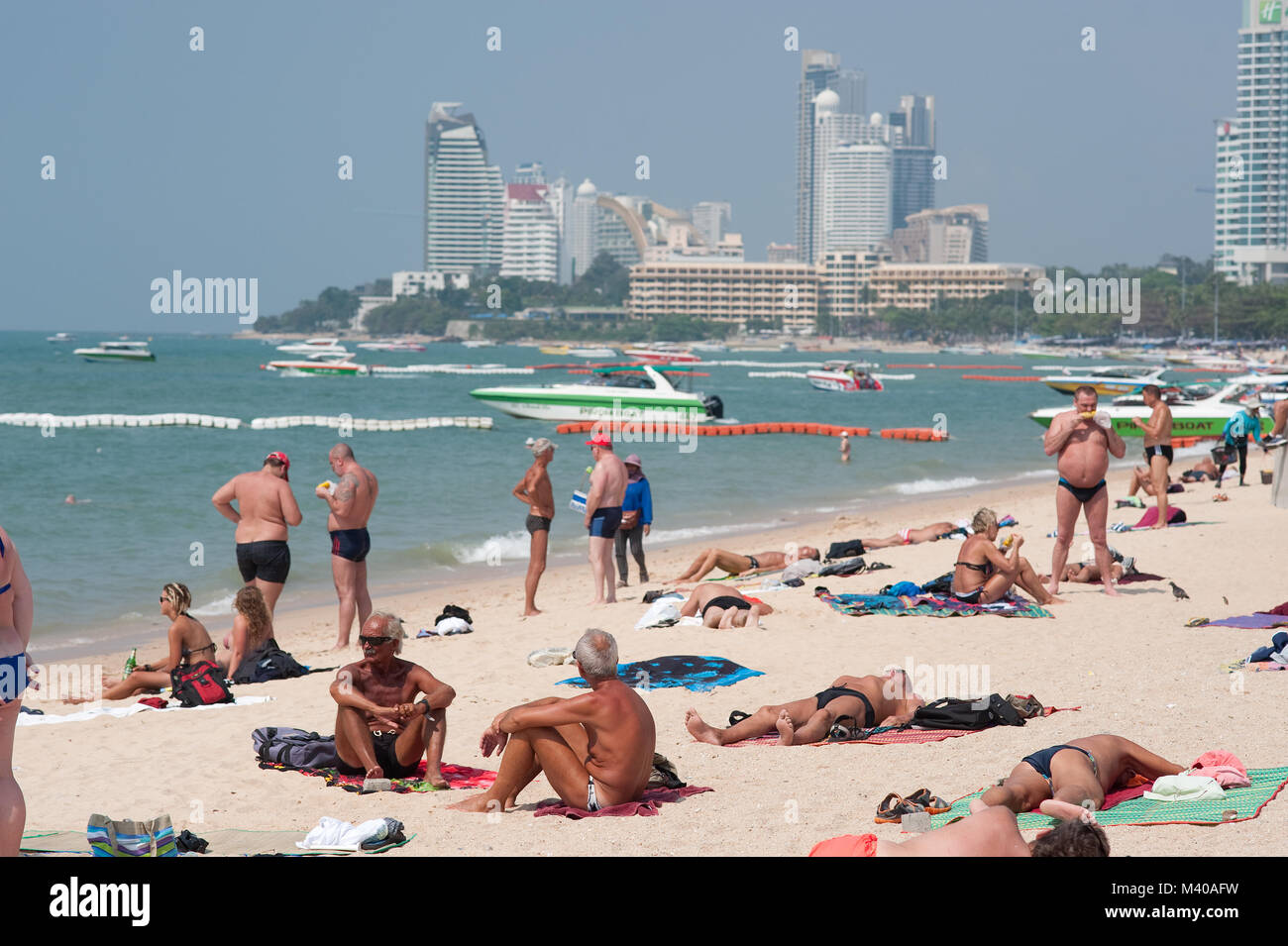 Sunbathing Tourists on Pattaya Beach Thailand Stock Photo