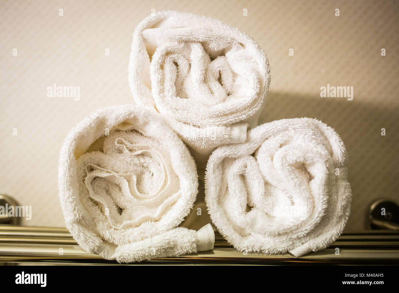Rolled white towels on a shelf bathroom Stock Photo Alamy