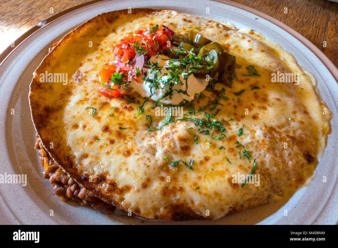 Vegetarian Enchilada Puy lentils in tortilla with melted cheese sour