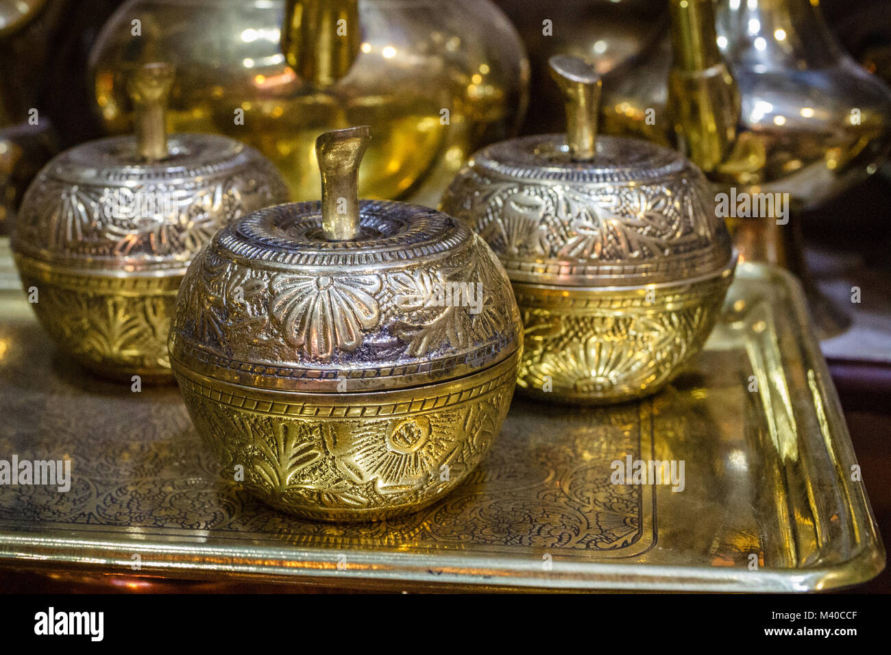 Bronze bowls in a shape of an apple on a tray at a market in Thamel, Kathmandu, Nepal Stock Photo