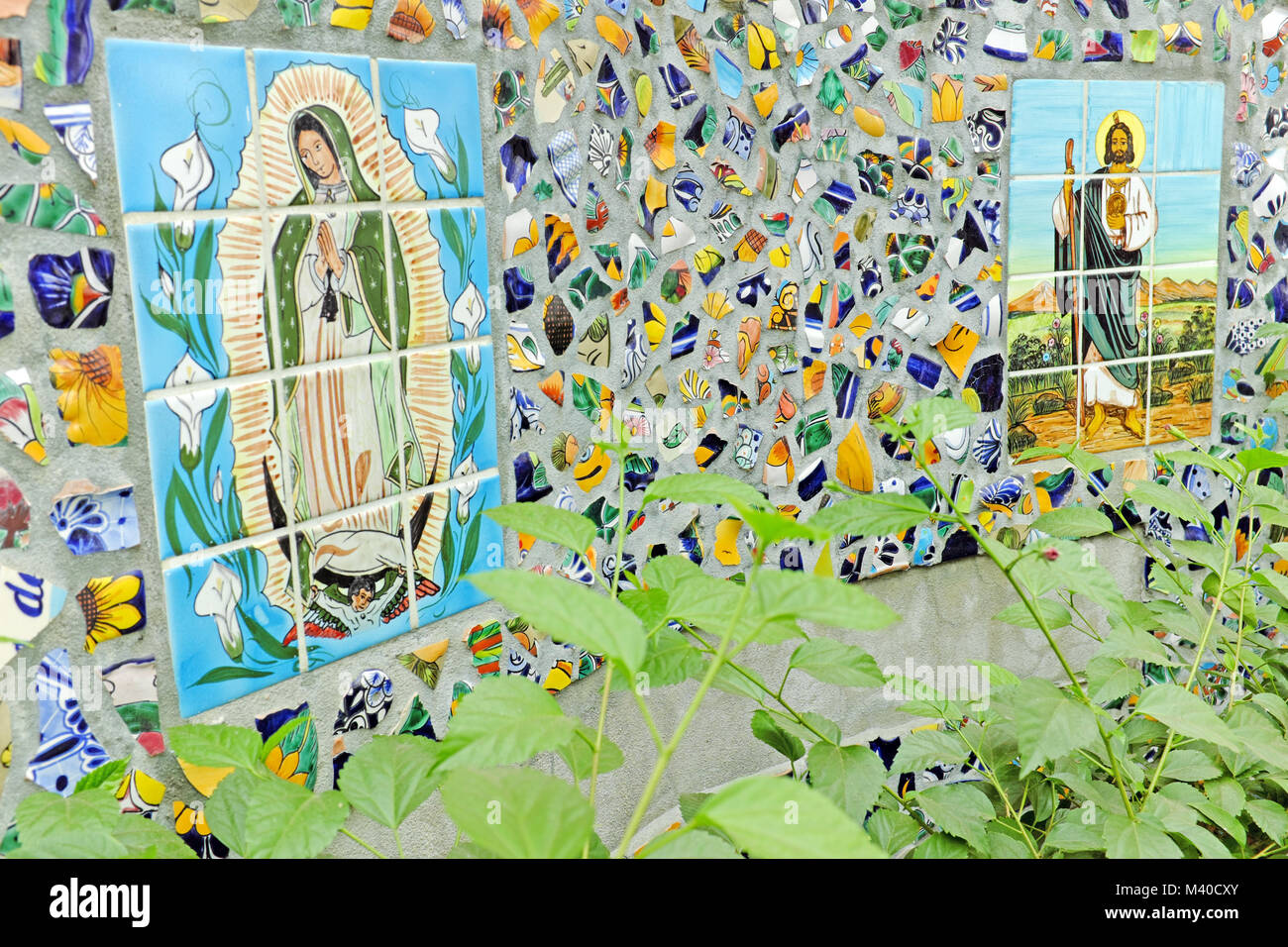 Public tile mosaic with religious icons of Jesus and Mary built into it colorful facade located on the streets of Puerto Vallarta, Mexico. Stock Photo